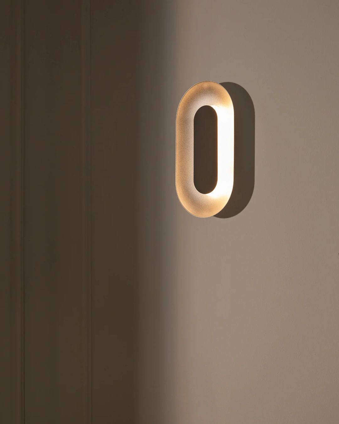 Aukso spalvos ovalus sieninis šviestuvas "Sasi Large" iš Nuura