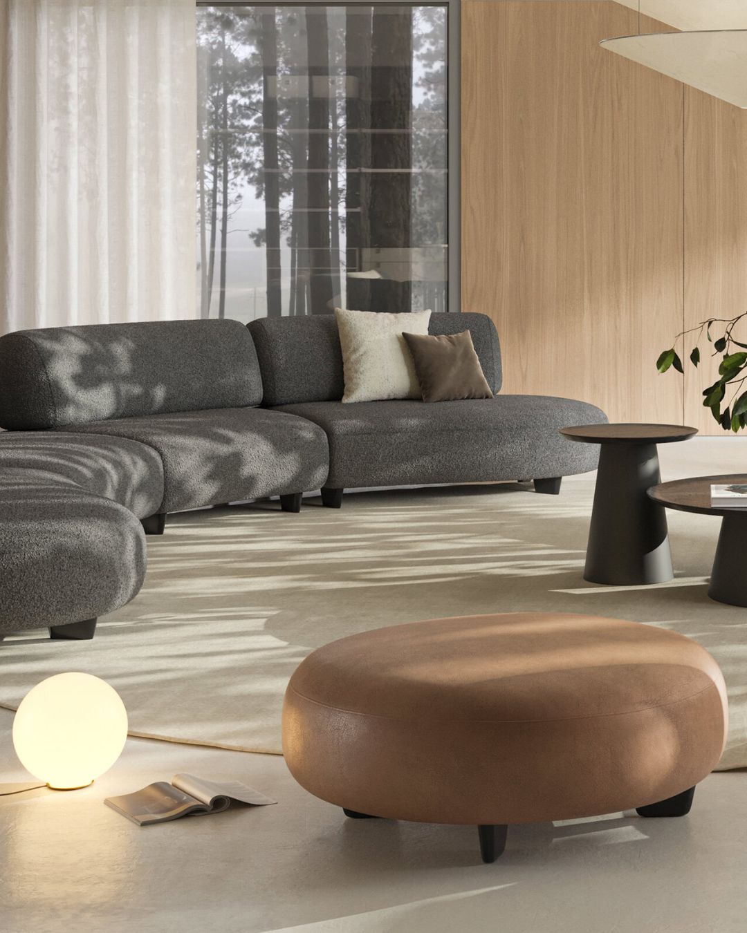 Rudos spalvos apvalus odinis pufas su žemomis juodomis kojelėmis - nuotrauka interjere